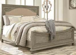 gray finish with white rubbed tops Made with pine solids and veneers with engineered board Shapely planked sleigh bed has tall lay-back headboard