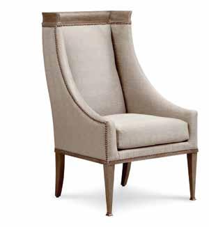 The warm gold tone of the back panel is repeated in the metal feet and collar on the square tapered front legs. The tailored seat and back are finished with self-welting.