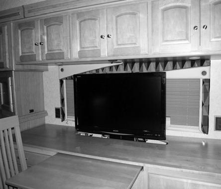 To lower the TV back into stored position, press the control switch DOWN. The power lift/lower mechanism will stop automatically when the TV is all the way seated into stored position.