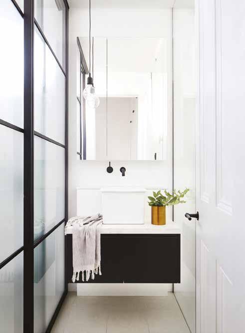 INSIDE homes ENSUITE Sliding steel-framed doors hide the shower and