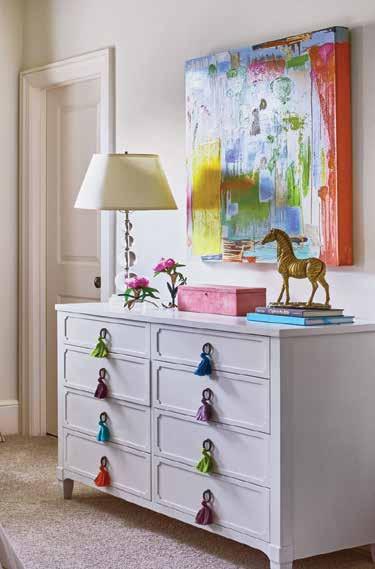 To keep the room transitional as the homeowners young daughter gets older, Zeller based the room s design on a neutral base and then added in pops of color via colorful fringe hanging from the