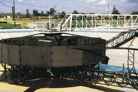 To provide complete sludge removal from all parts of the basin, the sludge-raking arms have pivoted pantograph-action extensions attached to their outer ends.