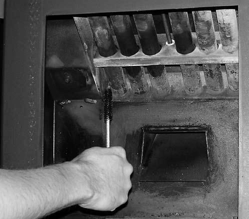 Heat Exchange Tubes Tube Scraper - Using the hole in the handle of the Grate Scraper Tool grab the scraper rod as shown in Figure 26.