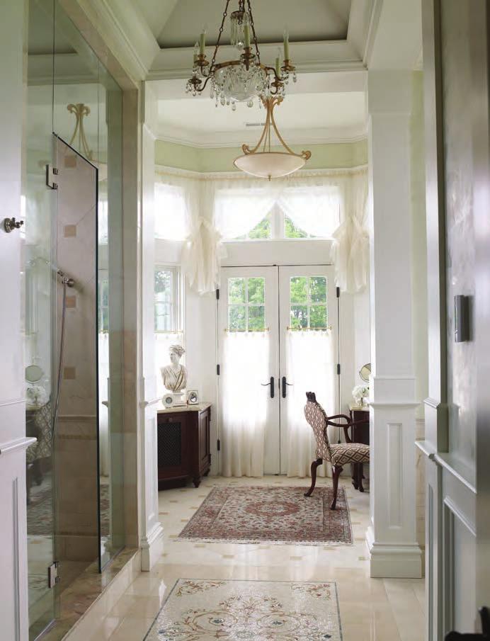 RIGHT An inlaid mosaic tile rug is from Castelli Tile. At the far end, French doors lead to the balcony. LEFT Windows in the vanity area, which flood the room with light, also offer an exterior view.