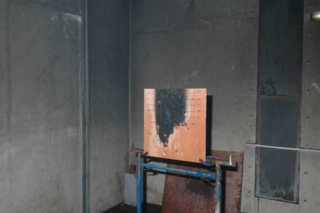 damage to the backing board. The plywood backing board did not burn through during the fire but was charred.