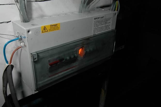 20 Research Report BD 2890 (E3V2) 293761 Figure 33 Plastic gap filler melted away showing the glowing hot wire loop in the metal consumer unit Figure 34 Flames visible behind the melting plastic