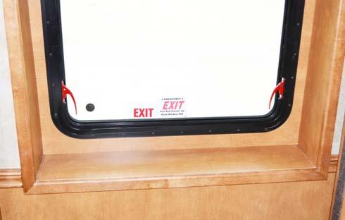 SECTION 2 SAFETY AND PRECAUTIONS WARNING Escape Window (Lift both red safety latch handles UP and push window OUT) Keep all persons clear of the slideout room and moving parts while extending or