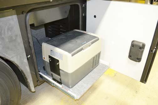 REFRIGERATOR/FREEZER PORTABLE If Equipped Your coach may be equipped with a 12/24- volt DC Portable Refrigerator/Freezer, which is mounted on a slide tray in a passenger side storage compartment.