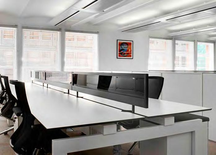 The never ending desk bench system has its origins in the offices of British architect Sir Norman Jones.