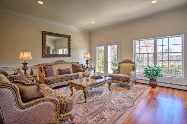 Living Room 17 x 16: French doors open to the front porch and increase the serenity of this formal space.