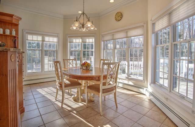 The breakfast room boasts matching custom pewter lighting and cherry cabinets for convenient entertaining.