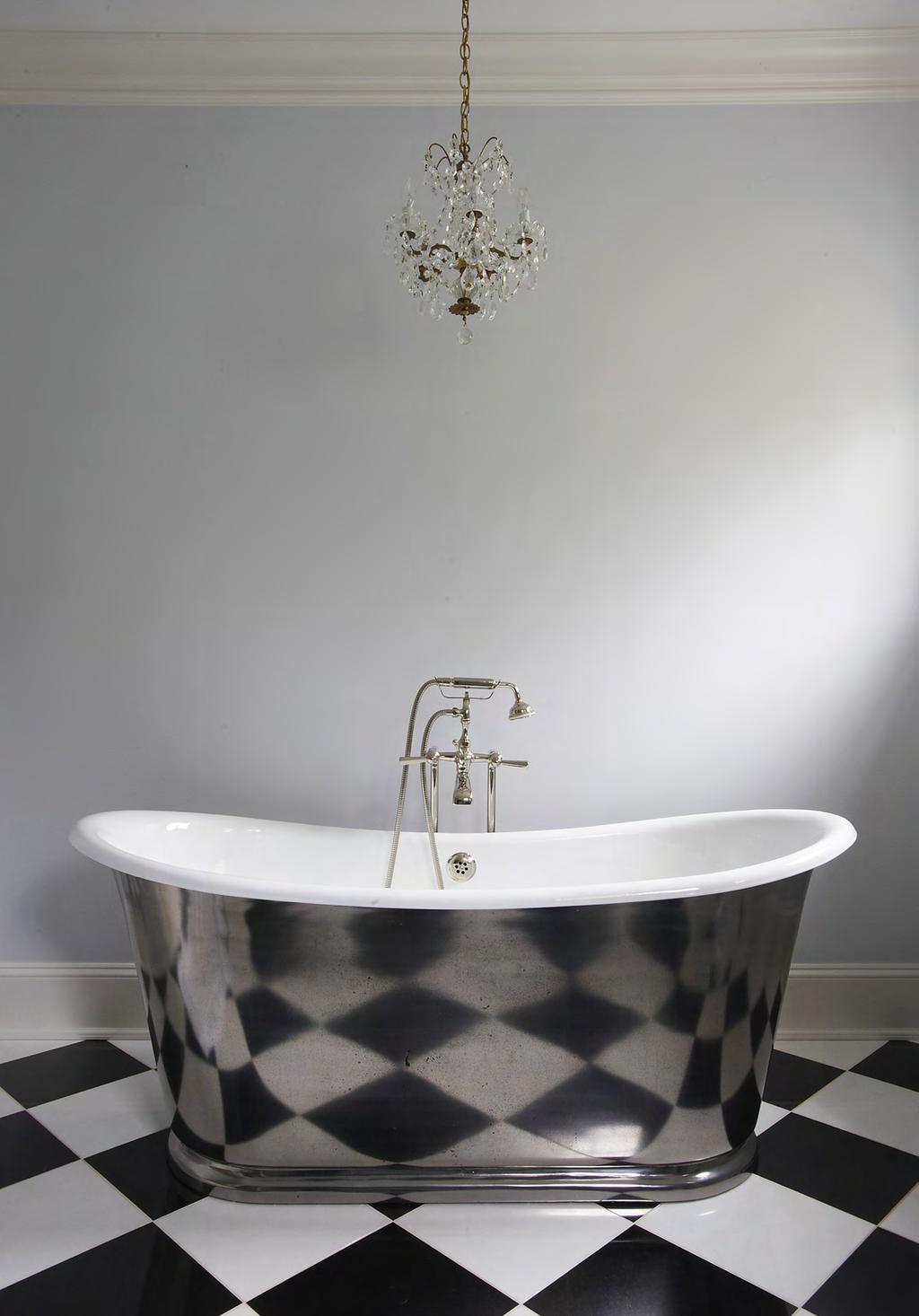 MASTER BATH, BED, AND BEYOND Impact pieces like this Waterworks tub, which beautifully reflects the checkerboard floor, make the master bath special.