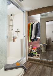 A double door vanity with a solid surface countertop, an integrated porcelain sink and a