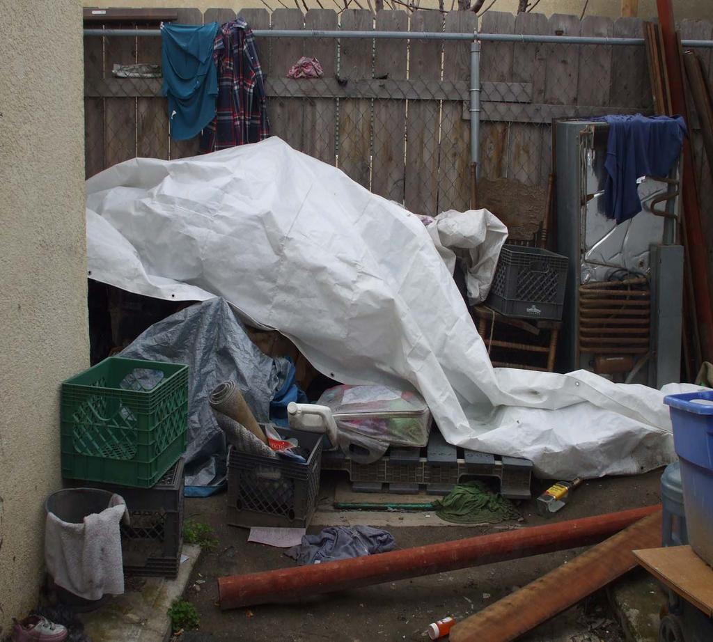 PHOTO 12: Showing accumulation of items outside cabin 3: Violation of the San Joaquin County Ordinance Code Title 8, Division 5 Housing and Nuisance Abatement Code; and the CA Health and Safety Code