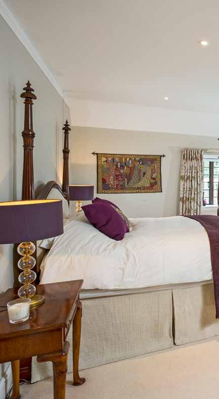 The master bedroom enjoys a double-aspect with French windows out to a private balcony overlooking the