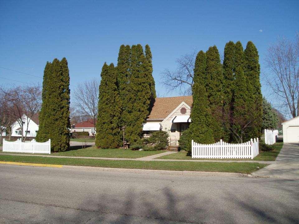 Scale use trees and shrubs to frame a house,
