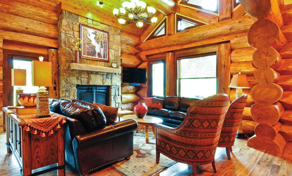 Oversized furnishings in the great room complement the impressive logs and wide windows.
