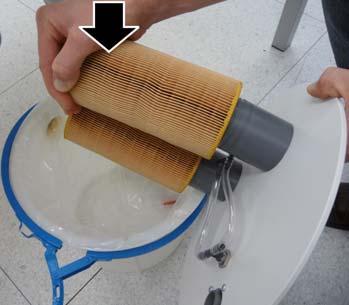 Release the filter cartridges by tilting them slightly. The springs remain attached.