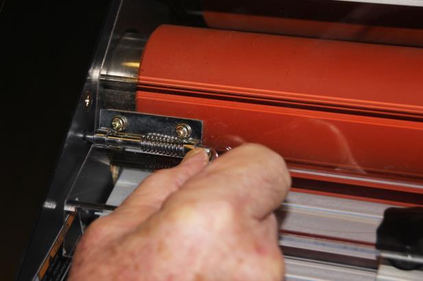 The laminator removes the polyolefin cover sheet before the film contacts the heated rollers; these rollers then fuse with heat and pressure the photo emulsion on to both sides