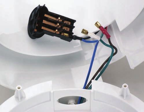 3. Locate the silicon tubing that connects the steam spout to the condenser coil. Figure Q 4. Disconnect tube. 5. Remove 4 black screws securing chassis to housing. 6.
