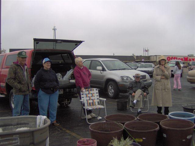 Damp but not soaked, Larry and Caryn Sheets, Pat Routh, and Duane and Mary Eberhardt take a break at the plant sale.