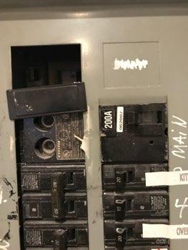 Circuit breakers missing exposing live electrical conductors. Electrocution hazard.
