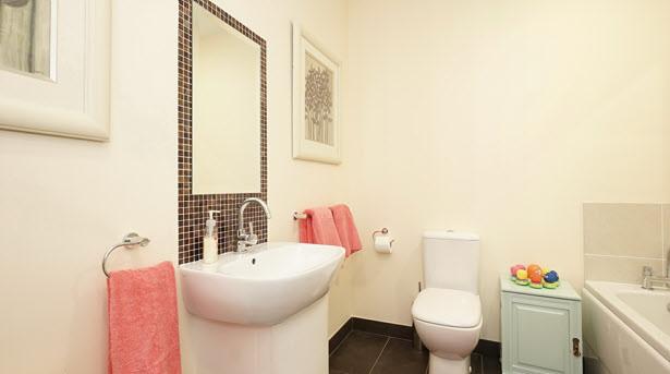 BATHROOM: Modern white bathroom suite comprising panelled bath with chrome mixer tap and