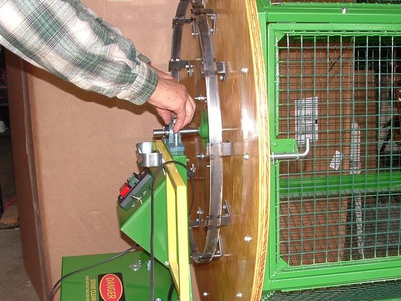 The tumbler must be placed on a level surface so the pillow-block bearing does not slide off the frame after the carriage bolts are removed.