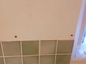green tiles behind worktops 1 nail & 3 picture hooks.