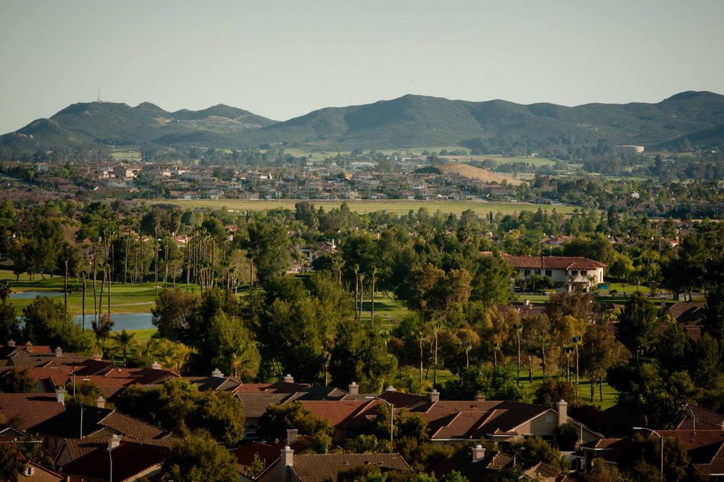 Residential neighborhood with hills in background.
