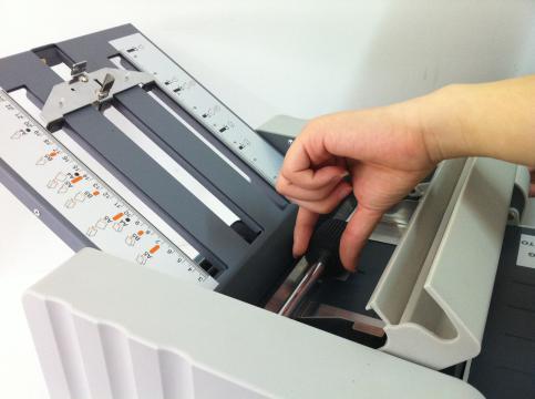 Make sure you have turned off the power before cleaning. 1.1 Clean the paper separator. 1.2 Remove upper & lower plate, open manual feed cover. 1.3 Remove the feed roller by pushing is aside and disengaging the other end.