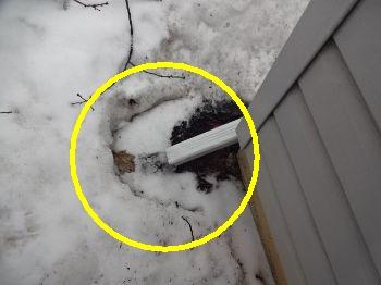 The downspout drains too close to the garage and foundation.