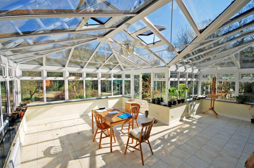 Fully upvc double glazed on three sides and overlooking the gardens with woodland beyond, double doors returning to the dining room. UPVC double glazed doors leading to the patio and rear garden.