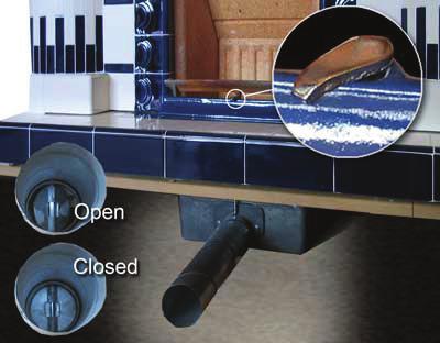 The air tube contains a damper plate that can be adjusted at the fret to enable the amount of air entering the fire to be regulated and hence the rate of burning.