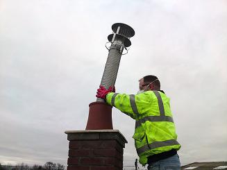 5) When the chimney liner is all the way through the flue, remove the nose cone and connect the base of the chimney liner to the appropriate adaptor using stainless steel self tapping screws and seal