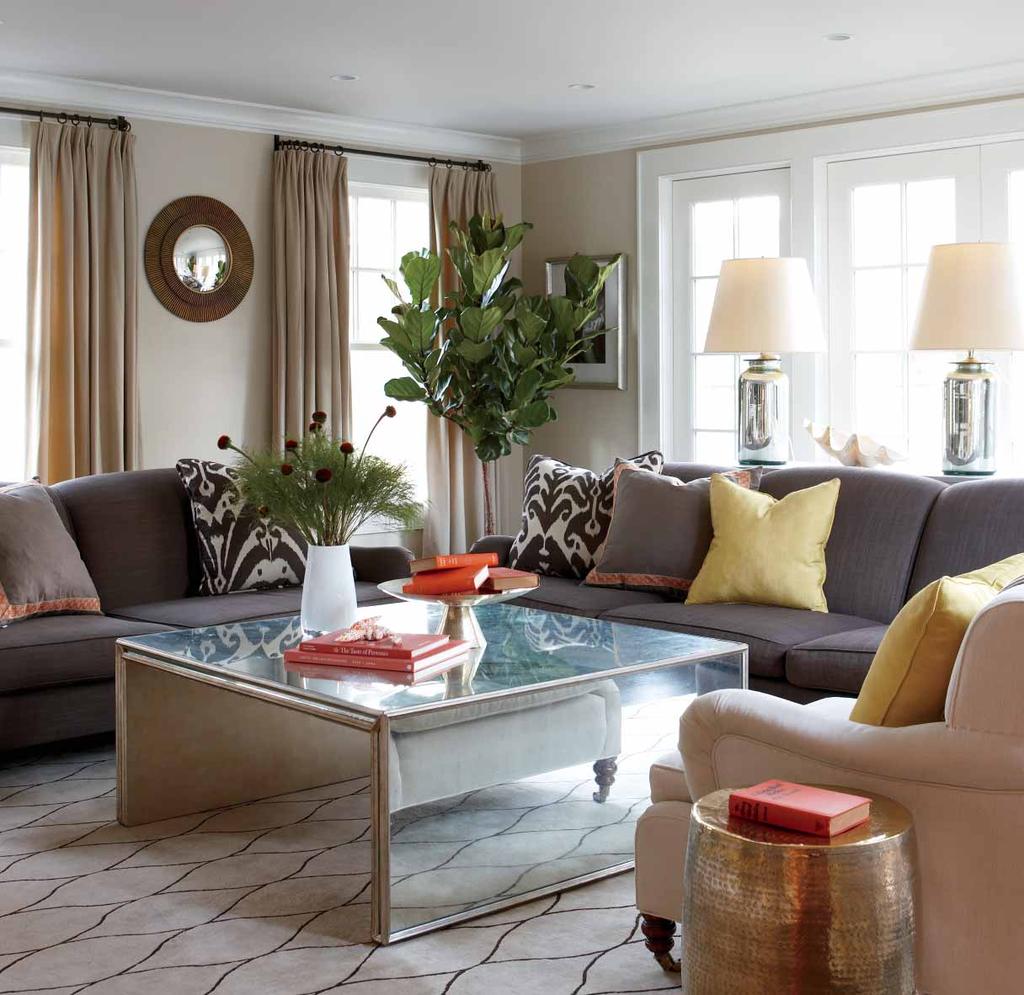 HODGE INTRODUCED A BIT OF PATTERN IN THE TAN AND CHOCOLATE-BROWN RUG AND SCATTERED TOSS PILLOWS TO LEND INTEREST TO THE PAIR OF CHOCOLATE-BROWN SOFAS.