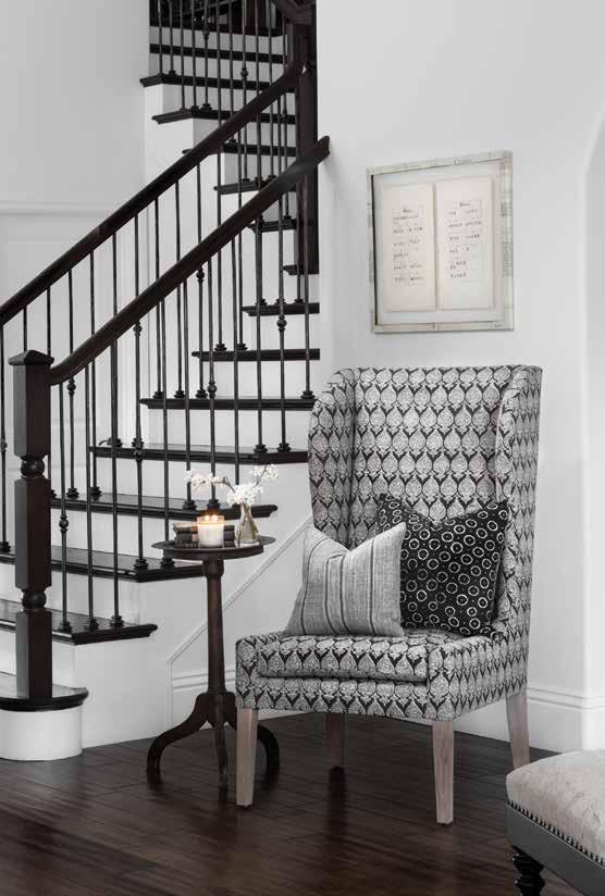 For a dramatic entrance, Kymberley Fraser finished an oak staircase in white with ebony treads and railings. Echoing the contrast is a wing chair covered in Sari Mole fabric from Raoul Textiles.