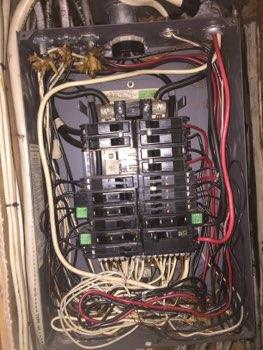Circuit breakers missing exposing live electrical conductors. Electrocution hazard.
