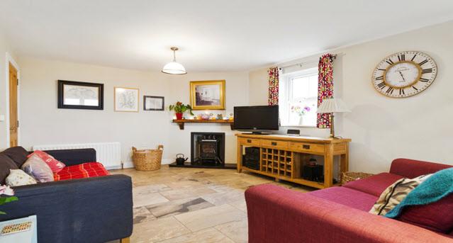 wood burning stove and slate hearth, low voltage spotlighting, porcelain floor throughout.
