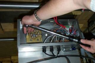 With the thermostat probe out of the way, use the 1/2 socket and ratchet to remove the nuts holding