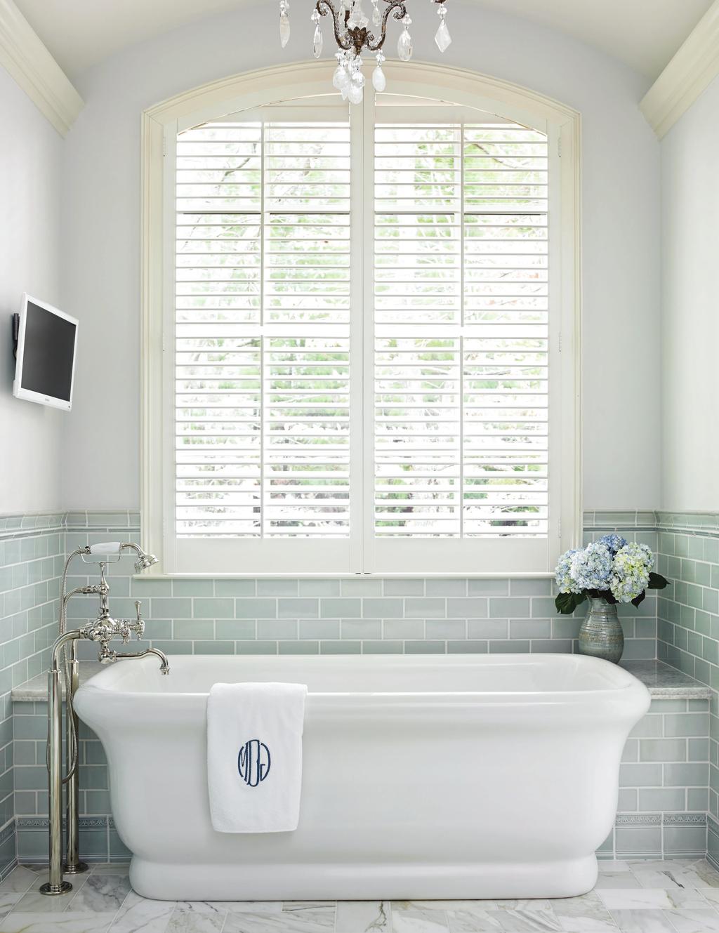 THIS PHOTO: Nestled in a sunlit nook, this sculptural tub is ideal for soothing soaks.