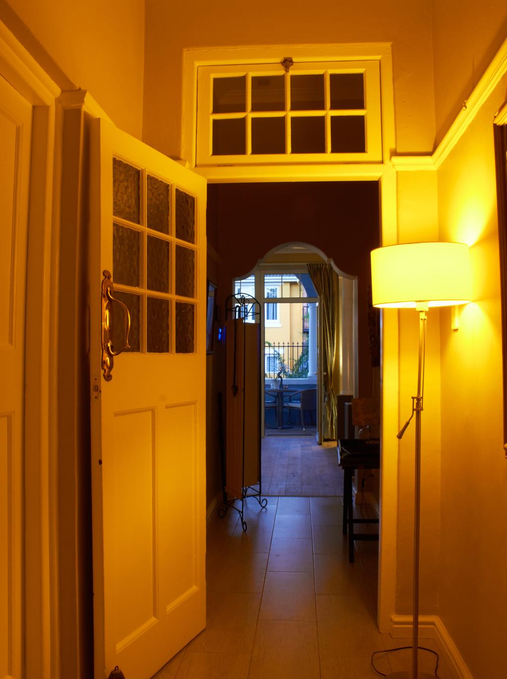 Being an old Victorian house, the passage way had several doors leading to the different rooms, including the kitchen.