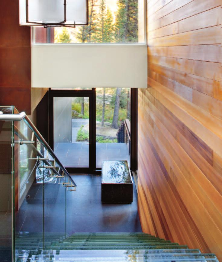 GLASS APPEAL Sunlight penetrates deep into the home s entry, where a glass staircase framed in stainless steel, designed by architect Jim Dayton and fabricated by Paragon Architectural Products in