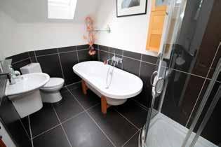 White WC, wash hand basin and free standing roll-top bath with mixer tap and incorporating