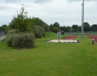 of grass sports fields, an outdoor running track, hard surface tennis