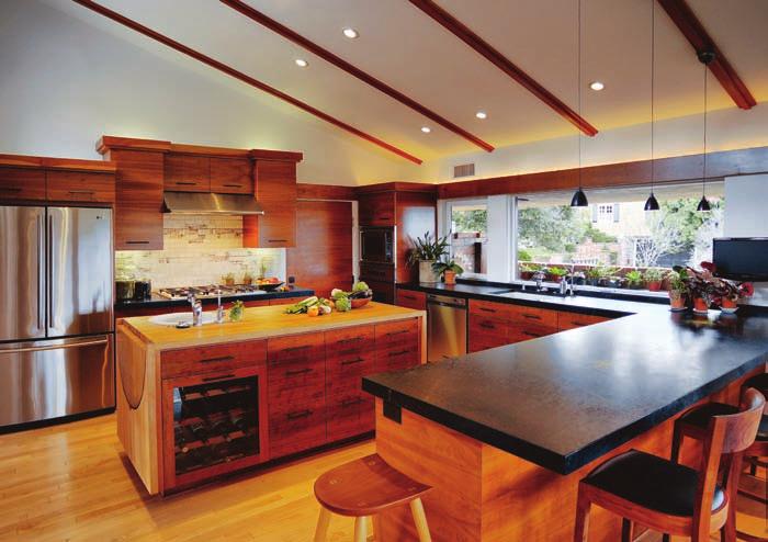 With the linear skylight above and a copper tile backsplash, the counter appears to float.