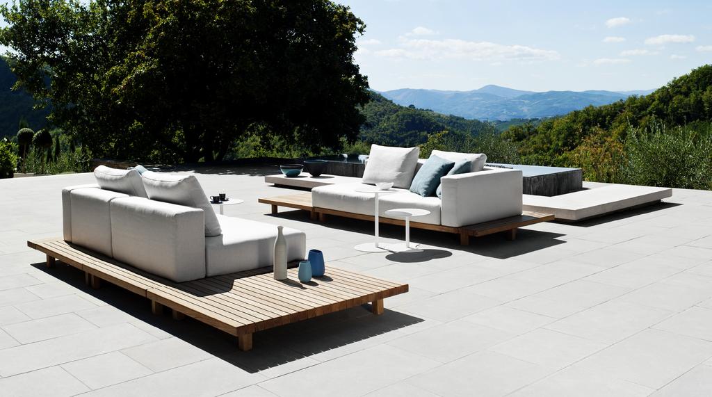 PIERGIORGIO CAZZANIGA DESCRIPTION The Vis à vis sofa brings an ode to pure design. Slender, teak platforms support comfortable outdoor cushions without any visible back or arm structure.