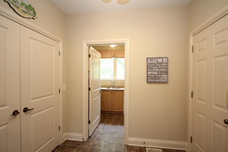A separate laundry area is featured with a full set of cabinetry allowing for