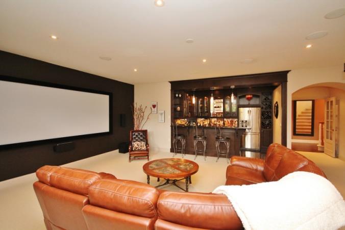 The Home Theatre: Double French doors lead you to the home theatre (24 ft x 21 ft) featuring a 125-inch