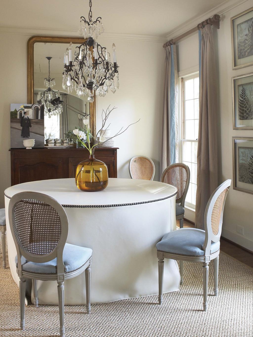 In the dining room, Dana recovered a round pine table with synthetic leather trimmed with nailheads for durable stylish appeal.